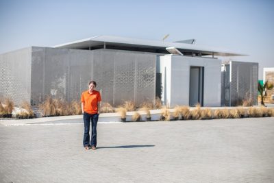 Student stands in front of FutureHaus